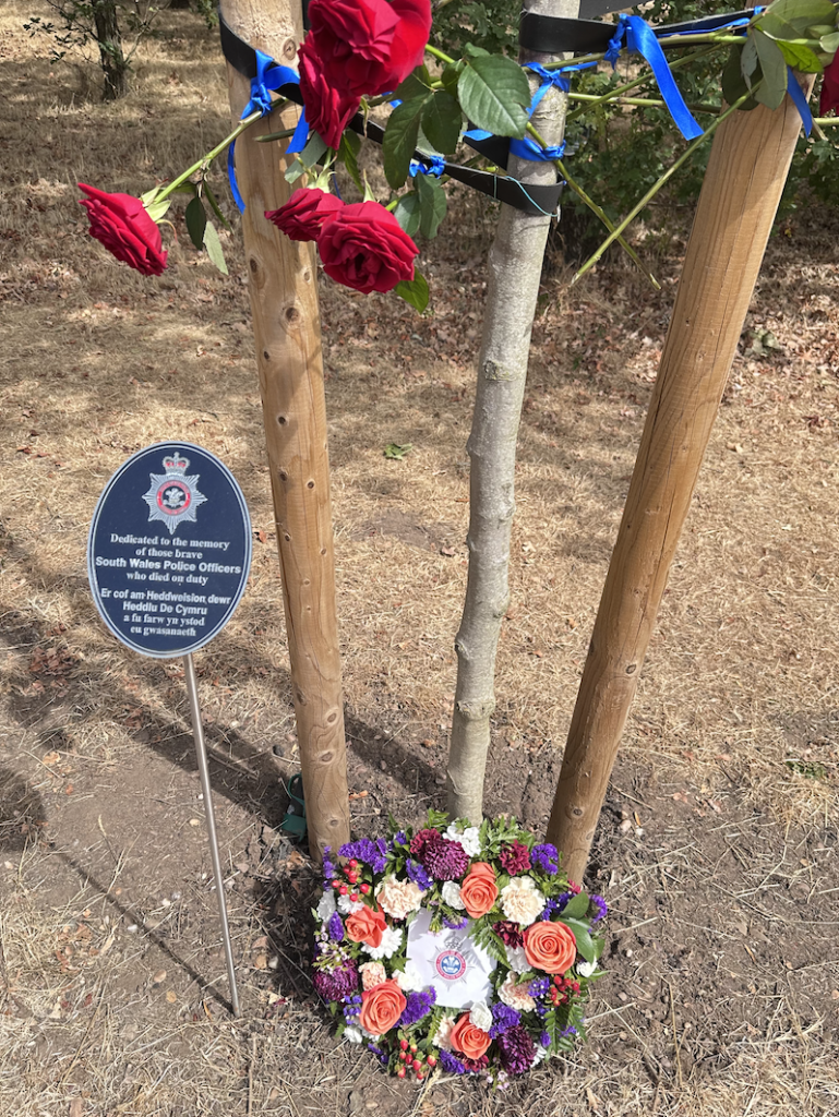Floral tribute to fallen South Wales Police officers at the National Memorial Arboretum.